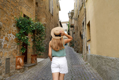 Tourism in italy. travel woman visiting historic medieval town of orvieto, umbria, italy.