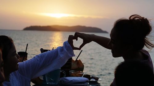 Silhouette of family at sunset