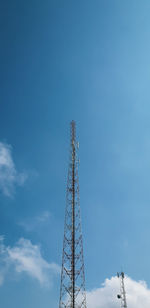 Low angle view of communications tower against sky