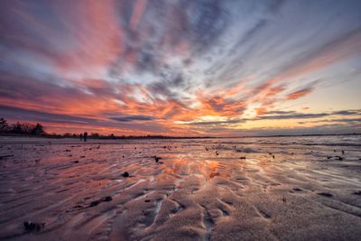 Scenic view of beach against sky during sunset