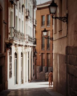 Full length rear view of woman in city