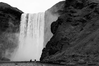 Scenic view of waterfall against sky