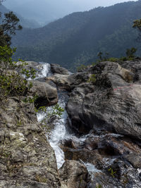 Scenic view of stream flowing through rocks