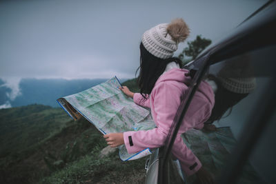 Rear view of woman reading book