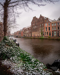 River amidst buildings against sky