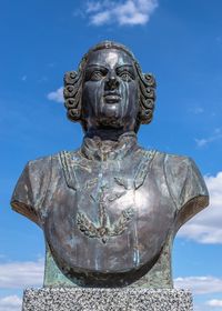 Close-up of statue against blue sky