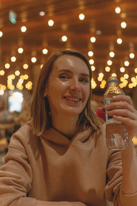 Woman with a bottle of water at the food court. millennial healthy lifestyle