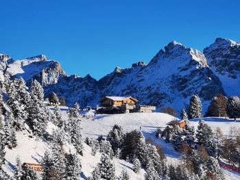 Scenic view of snowcapped mountains against clear blue sky