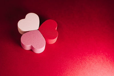 Close-up of heart shape against red background