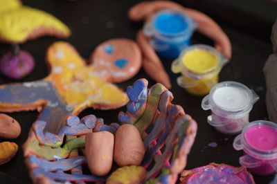High angle view of clay with watercolor paints on table