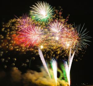 Low angle view of firework display at night