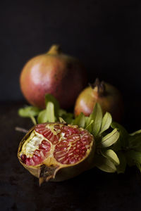 Close-up of fruits on table against black background