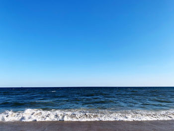 Scenic view of sea against clear blue sky