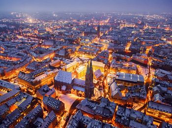 Aerial view of illuminated city at night