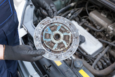 High angle view of mechanic repairing car