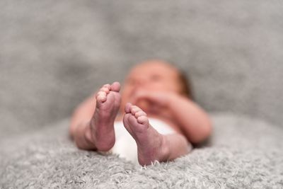 Close-up of baby boy sleeping on bed