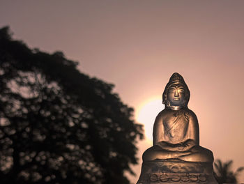 Low angle view of statue against sky during sunset