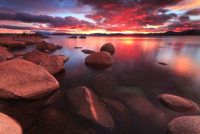 Scenic view of lake against sky at sunset