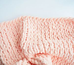 High angle view of pink sweater on table