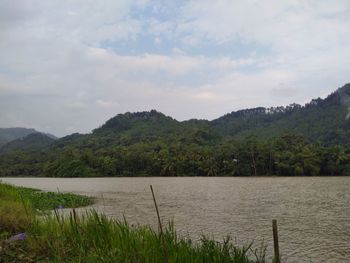 Scenic view of lake and mountains against sky