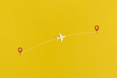 Toy airplane on a yellow background. top view. flat lay.