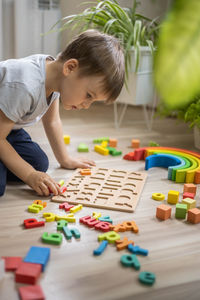 Boy playing with toy blocks on table