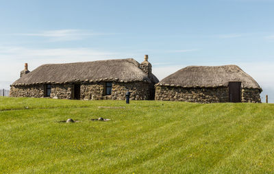 House on field against sky