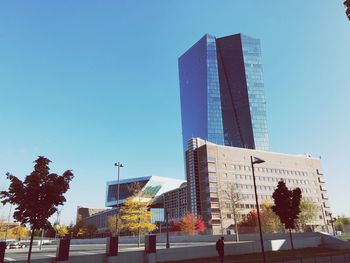 Low angle view of skyscraper against clear blue sky