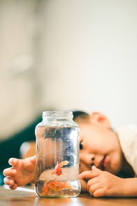 Midsection of boy holding glass