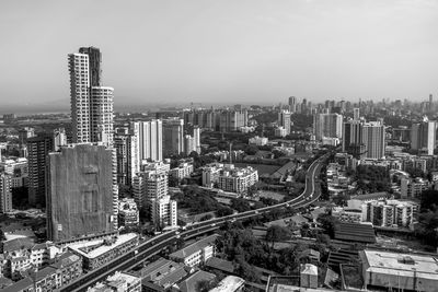 High angle view of modern buildings in city against sky