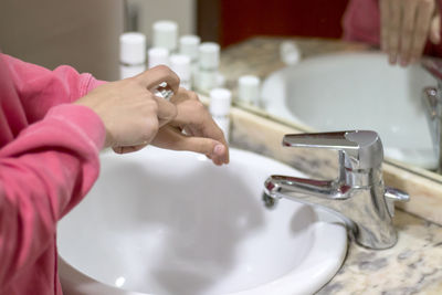 Cropped hand washing hands