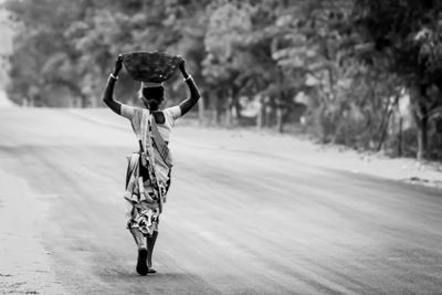 Rear view of woman standing in water