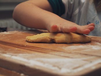 Close-up of person preparing food on cutting board