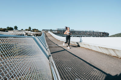 Female athlete running on steps