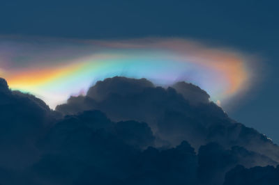 Low angle view of rainbow against sky during sunset