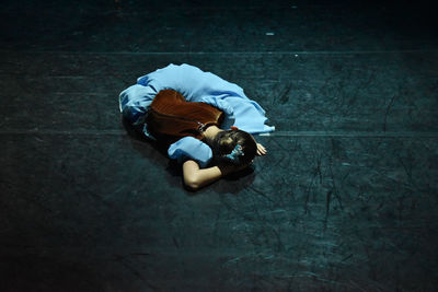 High angle view of woman sitting on floor