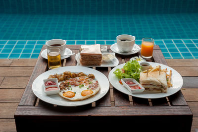 Close-up of food served on table at swimming pool