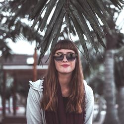 Portrait of smiling young woman wearing sunglasses