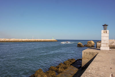 Scenic view of sea against clear blue sky