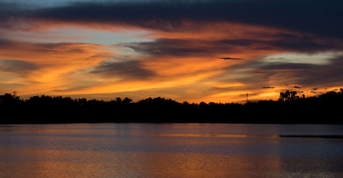 Scenic view of lake against romantic sky at sunset