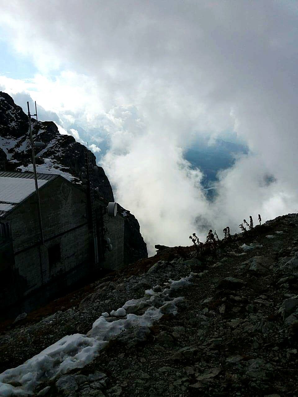 rock - object, nature, cloud - sky, low angle view, no people, winter, sky, outdoors, beauty in nature, mountain, day, architecture