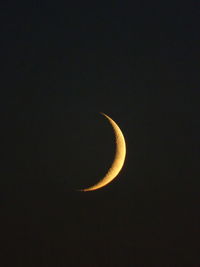Low angle view of half moon against sky at night