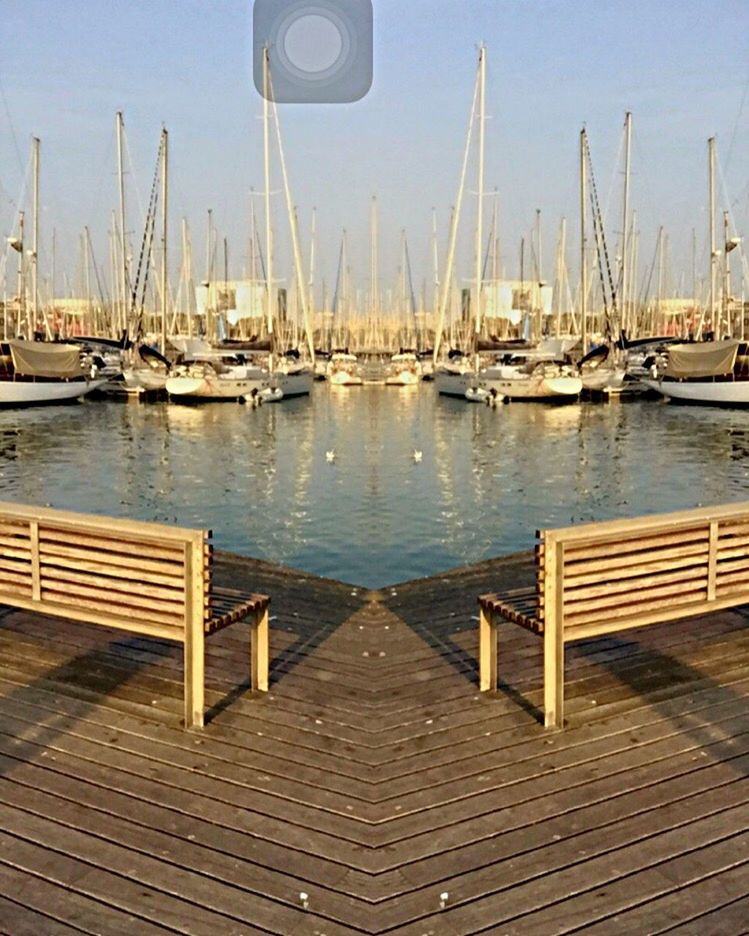 nautical vessel, moored, transportation, water, boat, mode of transport, harbor, pier, clear sky, mast, sea, marina, sky, blue, in a row, sailboat, reflection, outdoors, wood - material, jetty