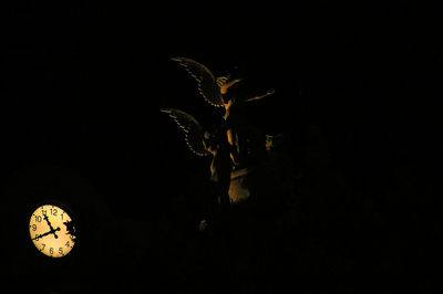 Close-up of illuminated light against sky at night