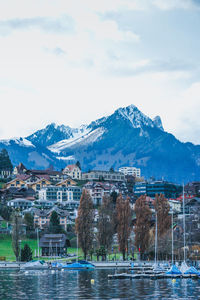 Scenic view of lake by buildings against sky