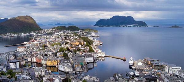 Panoramic view of city by sea against sky