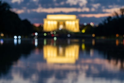 Reflection of illuminated building in water at night