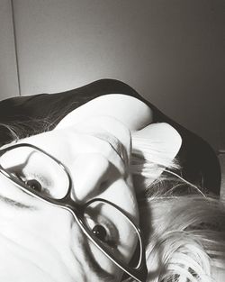 Close-up of young woman on bed at home