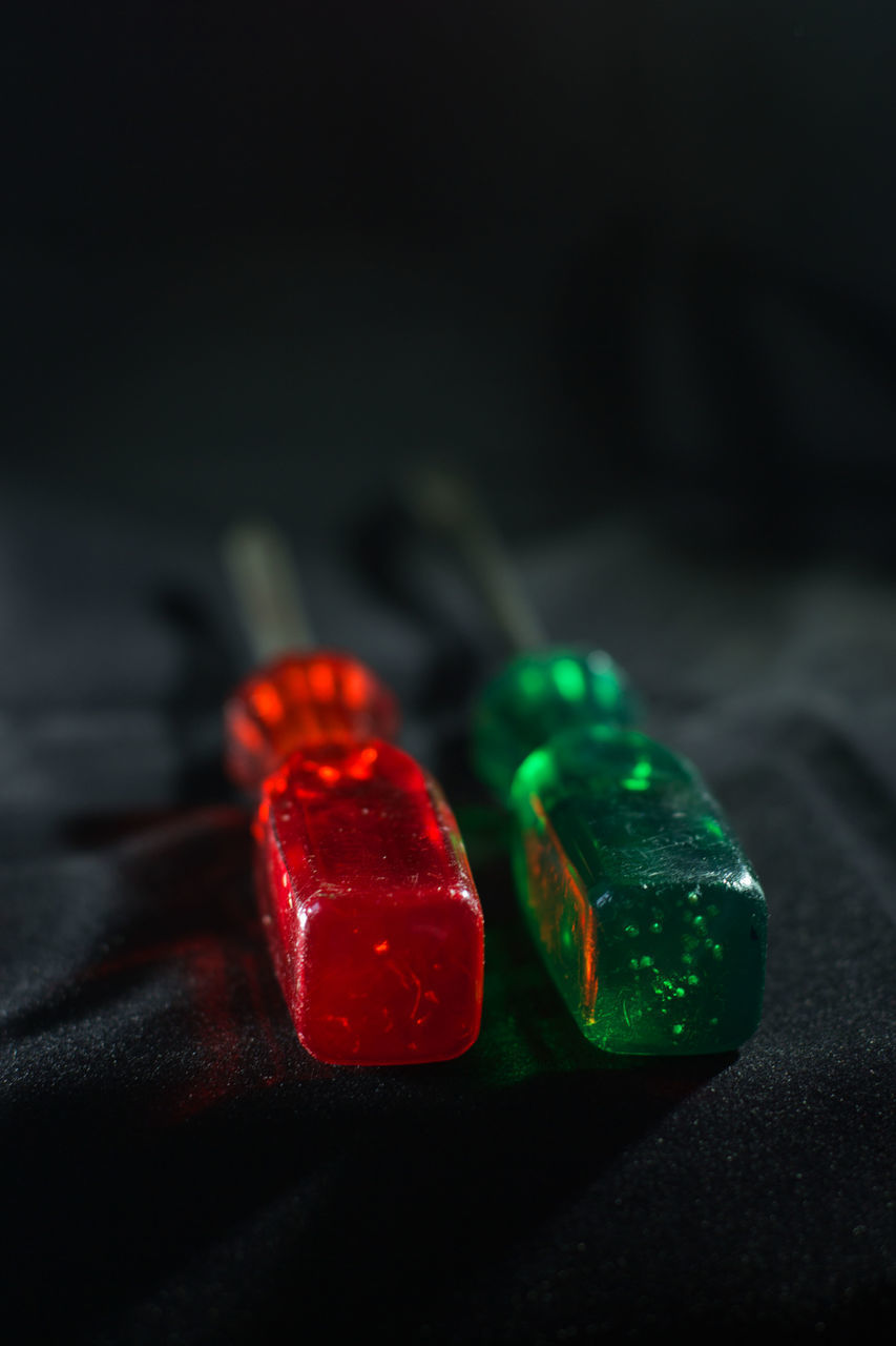 CLOSE-UP OF MULTI COLORED LIGHTS ON TABLE