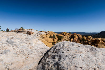 Landscape of massive white and yellow rock formations atop el morro national monument in new mexico
